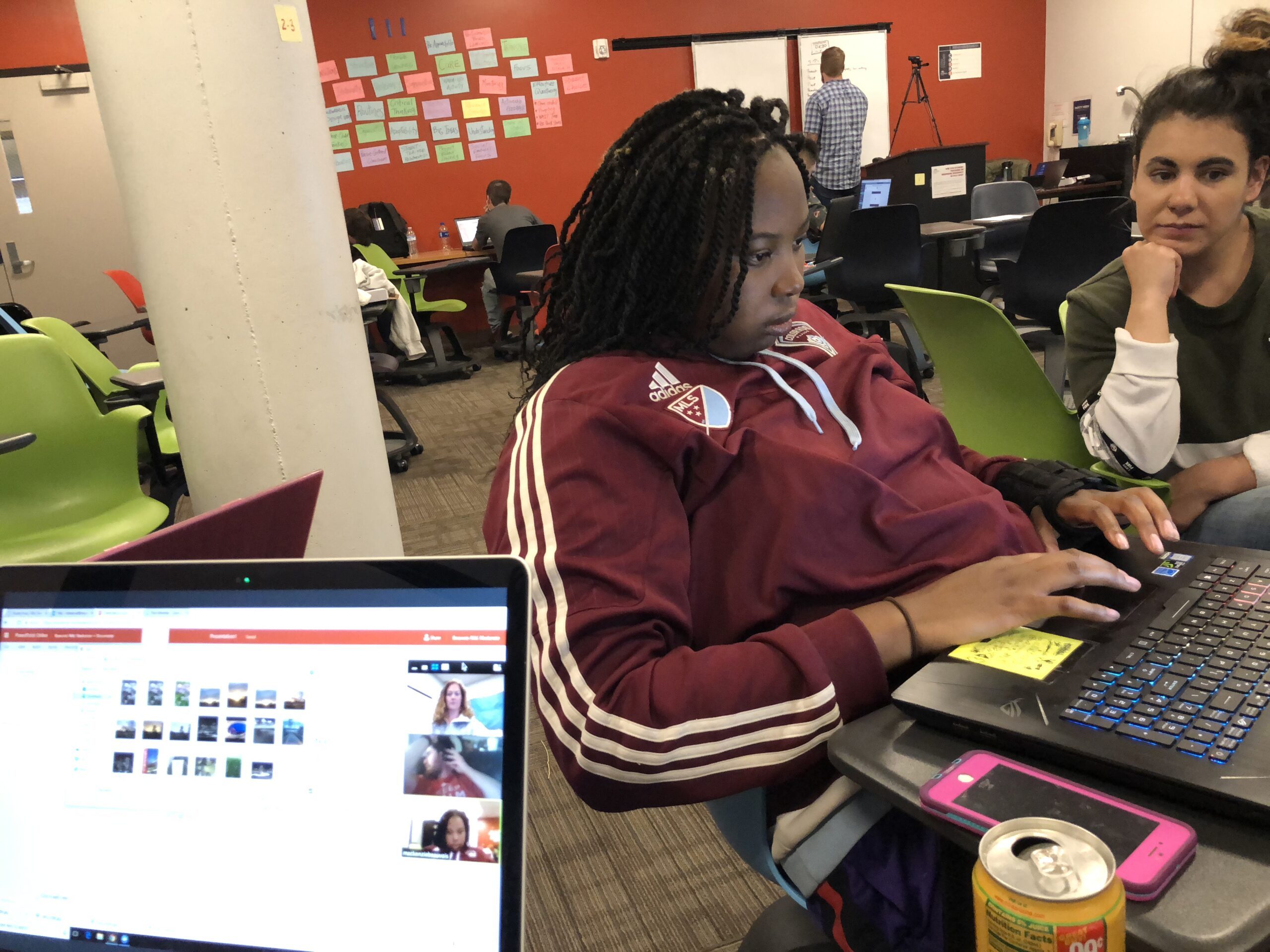 Decorative: Two Inclusive Higher Education Students work at a laptop