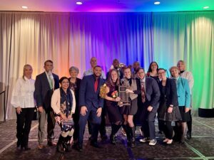 Jesiah front and center in this photo with MSU Denver Department of accounting faculty, staff, student leaders, and MPAcc alumni at the 2023 COCPA Gala winning the Battle of the Brains competition
