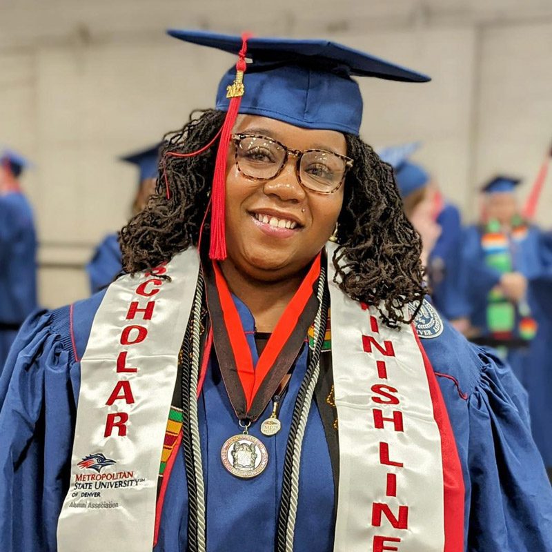 Alysha Harlan at graduation in her gown and cap