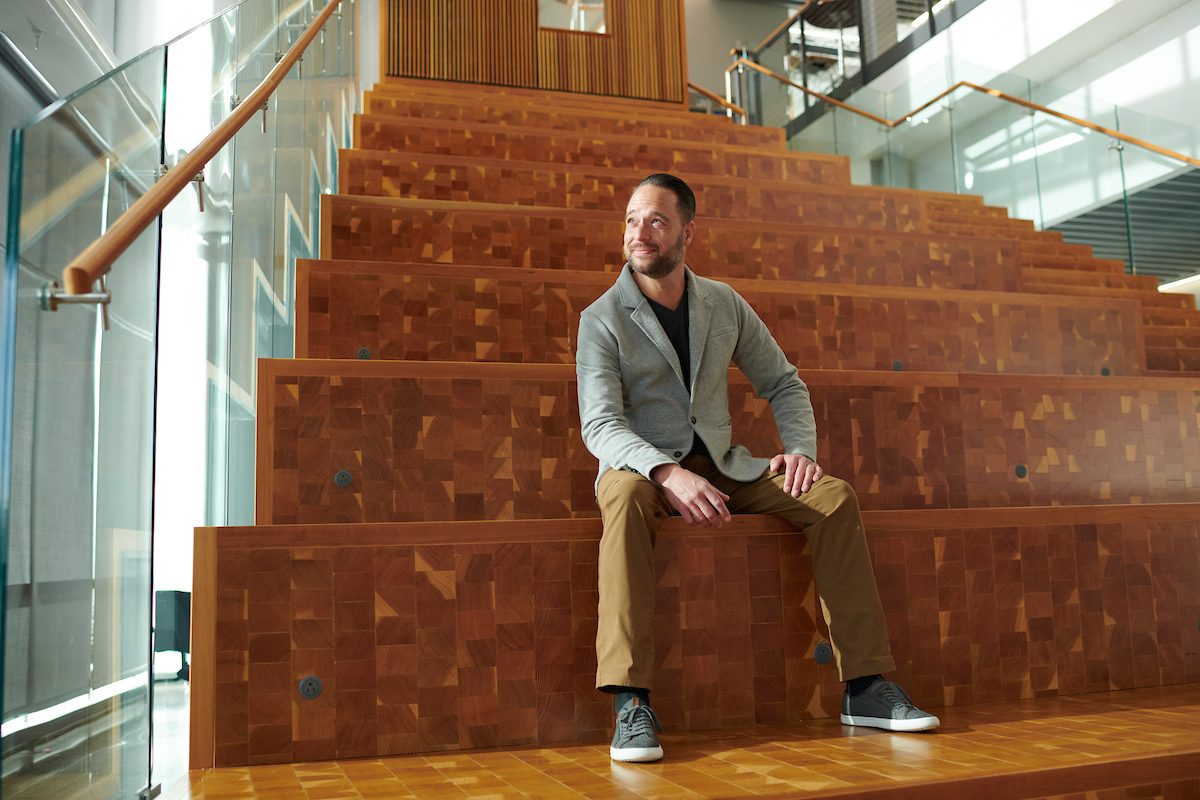 Student sitting on stairs in the AES building.