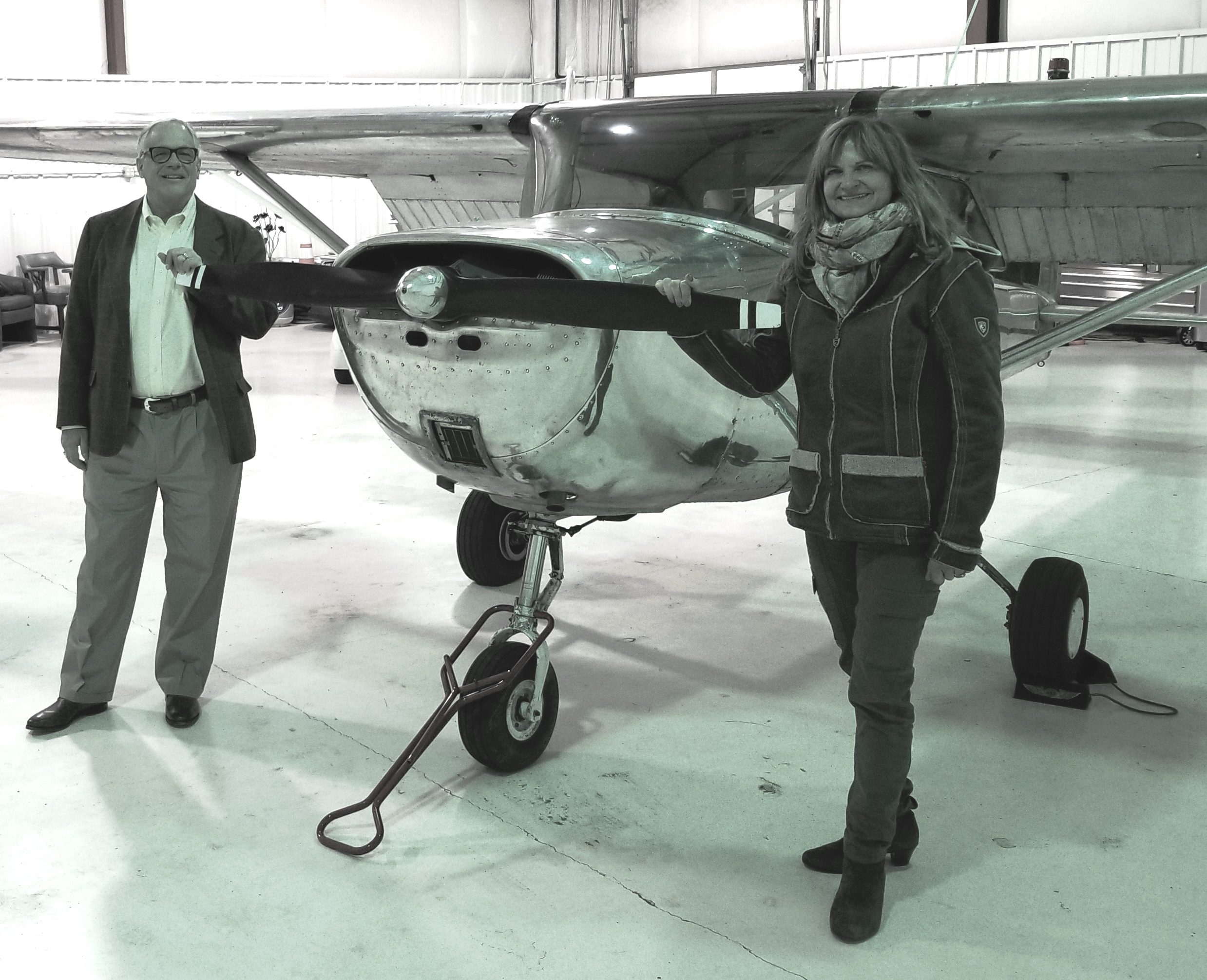 Department Chair Dr. Jeffrey Forrest and Faculty member Dagmar Kress stand by a single-engine airplane.