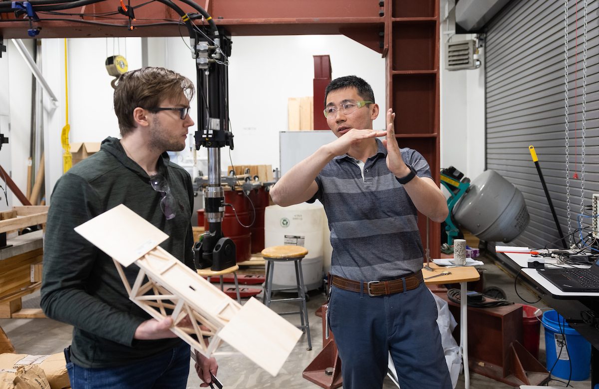 Ryan Walker talks with professor Yishi Lee in Introduction to Mechanical Engineering.