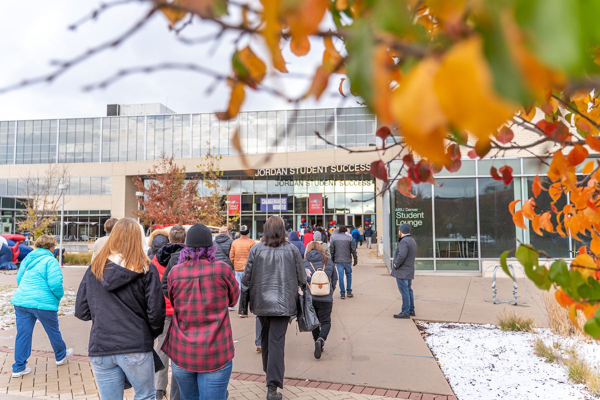 picutre of campus amongst the fall leaves with snow on the ground