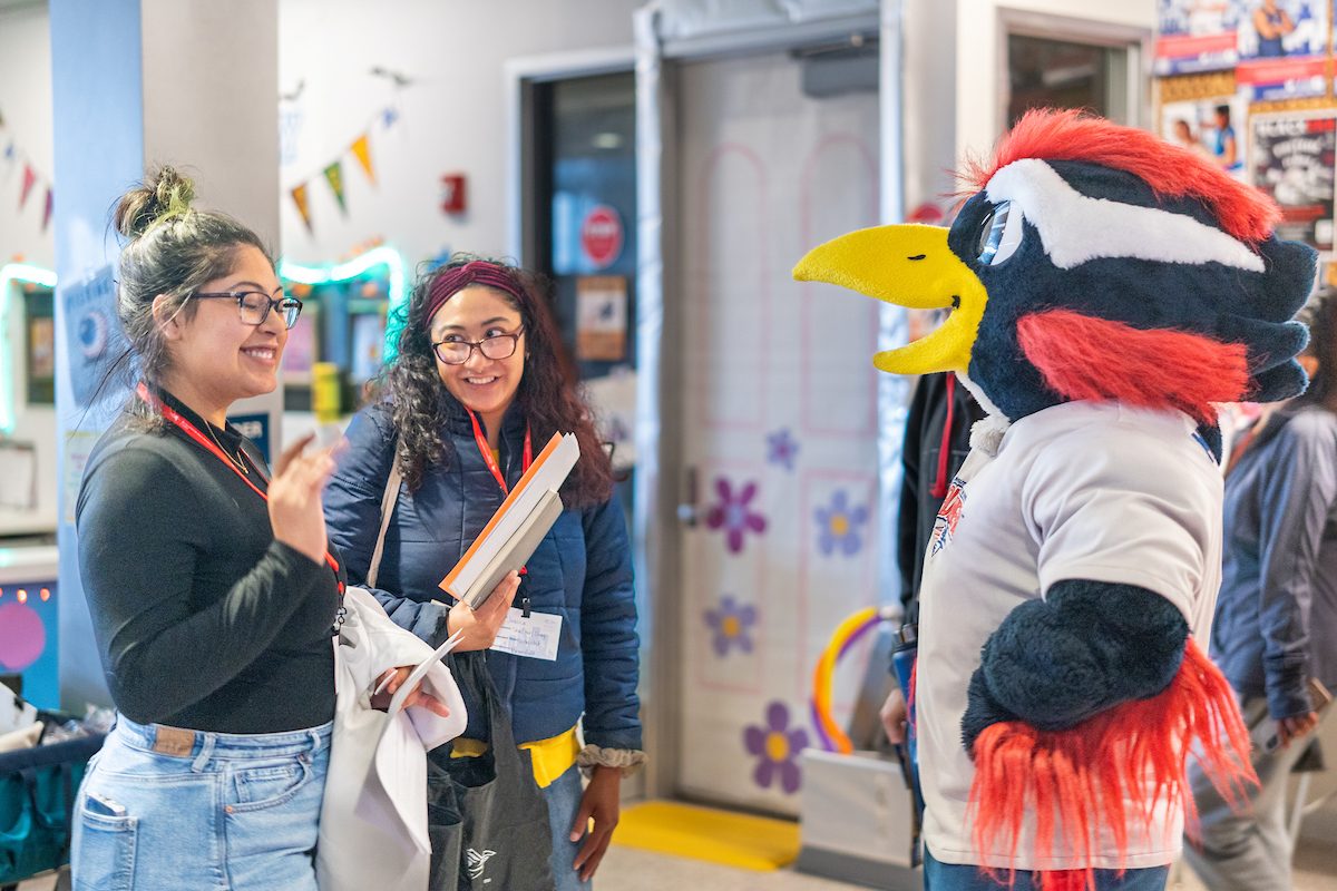 Rowdy talking with two students