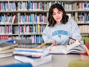 Abrianna Mangiamele, a third-year MSU Denver student majoring in Public Relations, works as a student intern for the OER task force and is seen here studying at the library.