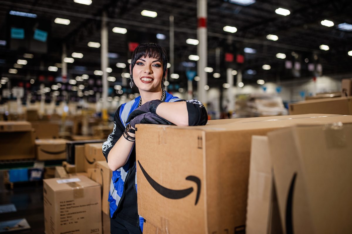 MSU Denver's Shanae Metcalf, an art major and digital media minor, poses in an Amazon warehouse, where she works her day job