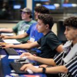 students speak with advisors during event in a classroom
