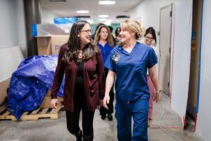 MSU Denver nursing faculty, Jenny Allert, DNP, MSN, RN, assistant professor, left, and Mary Tucker, DNP, RN, CRN, CHSE, Director of Interprofessional Simulation and Skills Hub, right, walk through the halls of the new SIM LABS on Feb. 26, 2024. Photo by Alyson McClaran