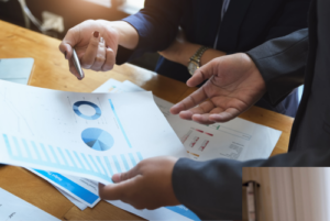 Overhead shot of two people reviewing financial documents.