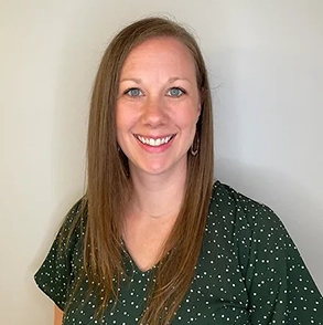 photo of Whitney Kramer, Part-time Clinical Educator, white woman, brown hair, blue eyes, smiling, wearing green shirt with white dots