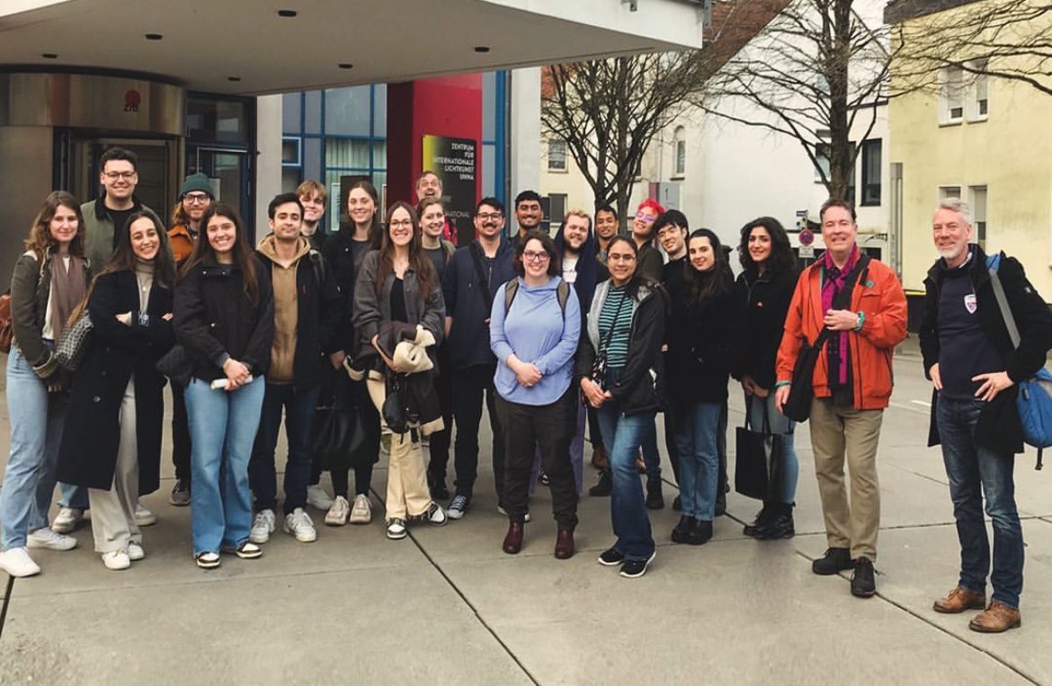 Students standing outside of building entrance