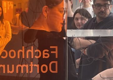 Looking through orange-stained plastic at students