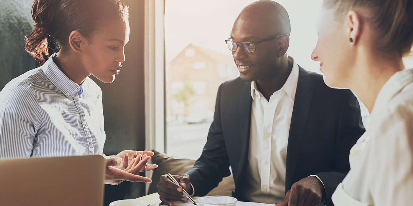 Three people in a business meeting