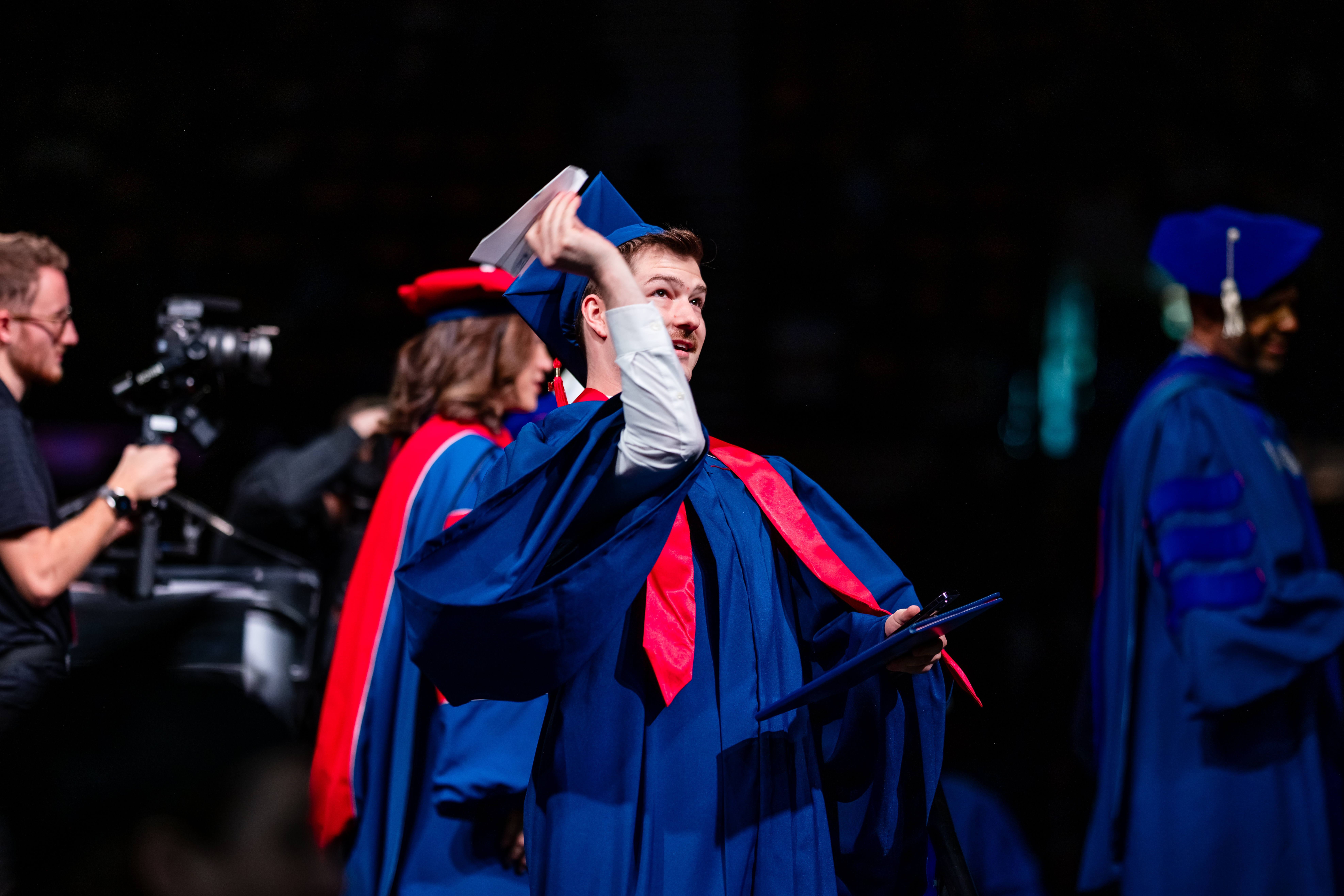 CACED student during the Morning Ceremony throwing a paper airplane for the Aviation and Aerospace department.