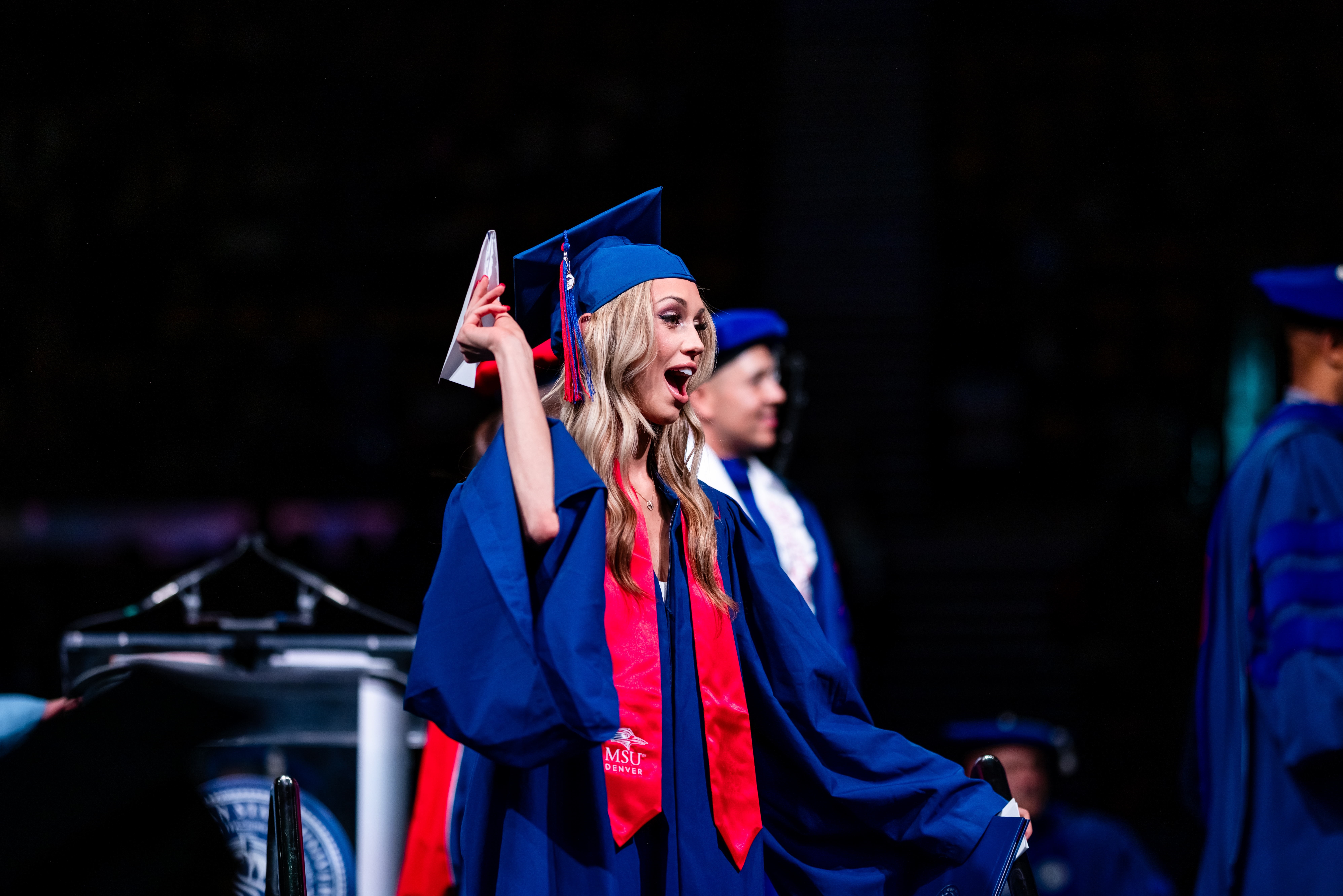CACED student during the Morning Ceremony throwing a paper airplane for the Aviation and Aerospace department.