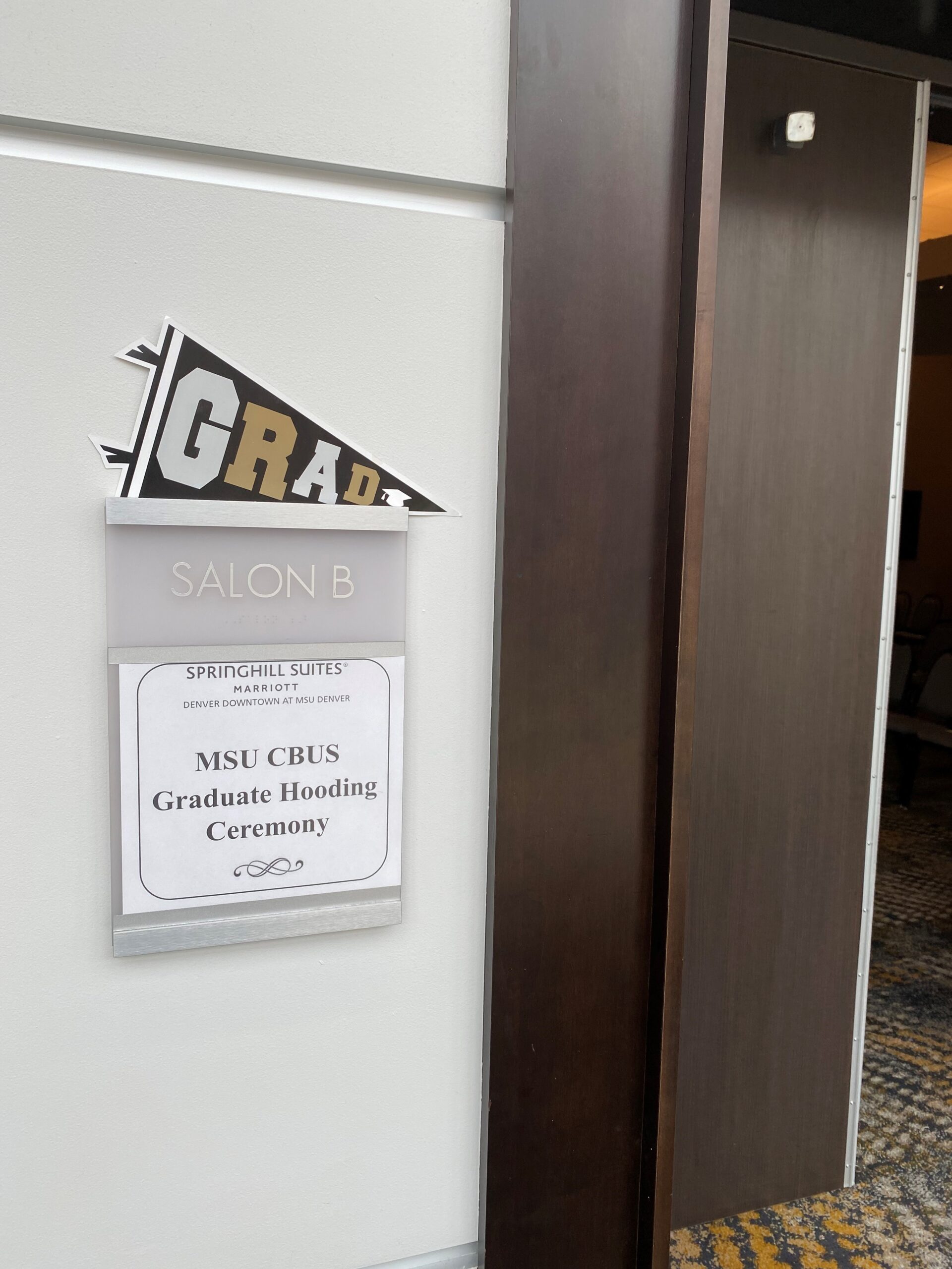 Sign on the door of the banquet room of the SP'24 MBA & MPAcc Hooding Celebration