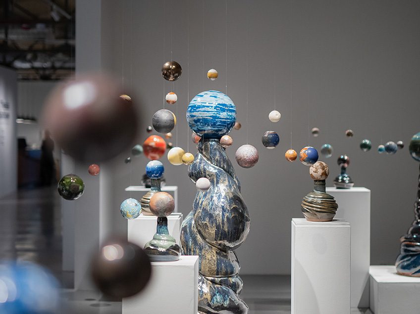 Sculptures reminiscent of the solar system, each ball is decorated with different glazes and surround the tallest globe.