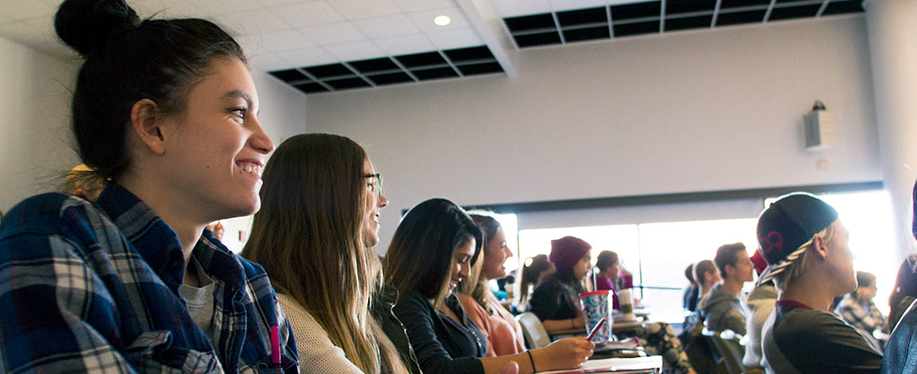 Students sitting in a classroom, looking forward.