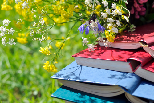 Books in a field of flowers