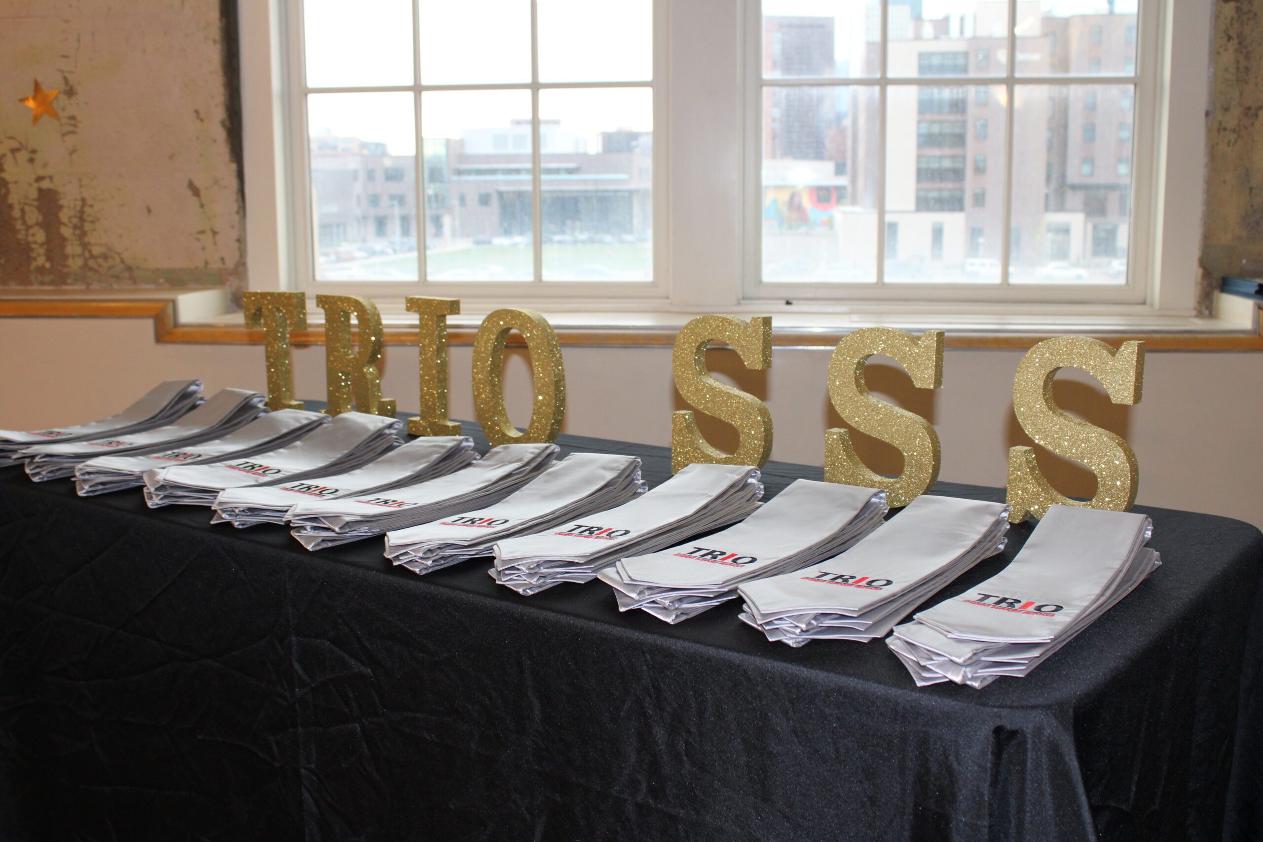 Table with TRIO SSS graduation stoles