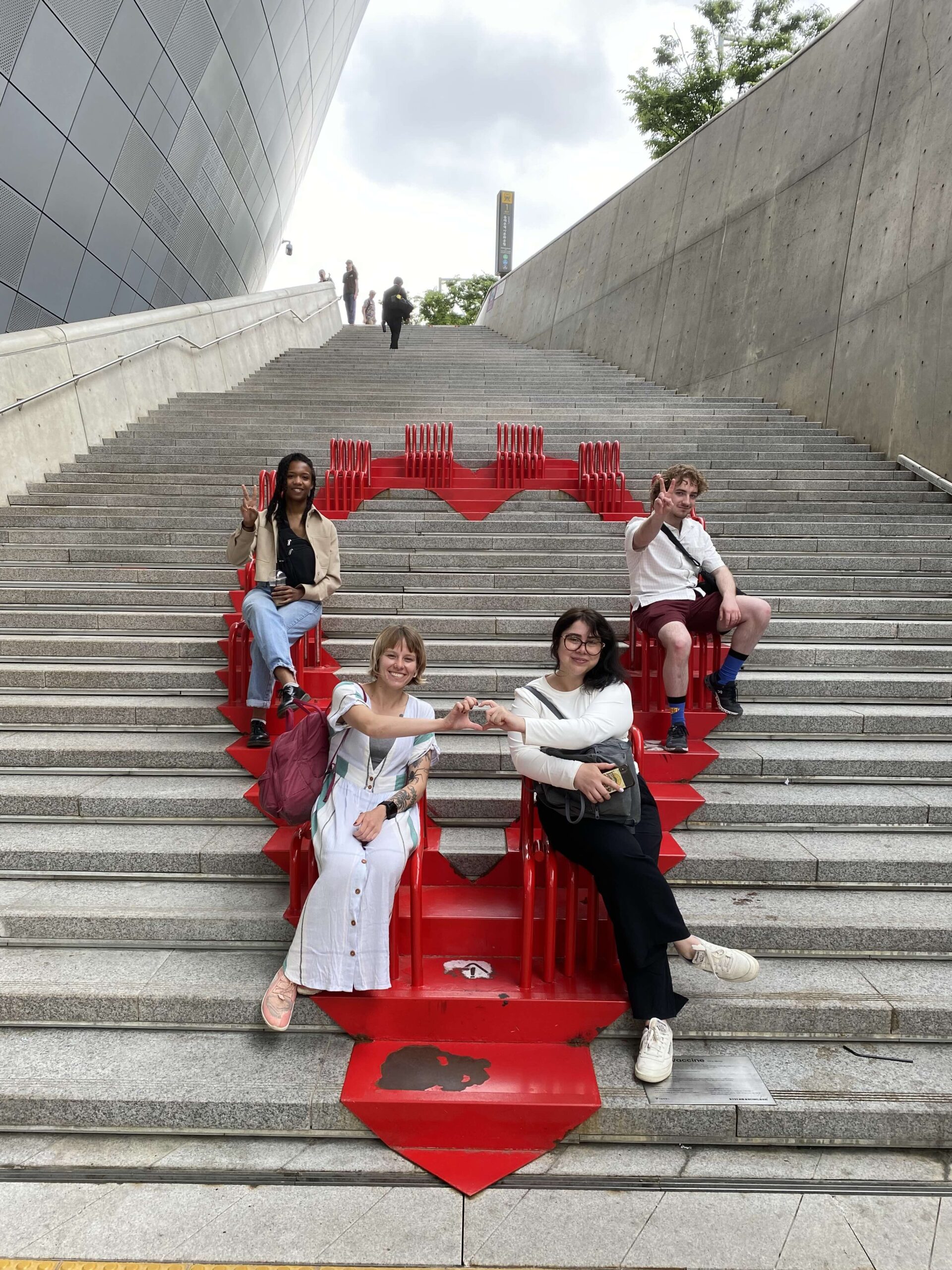 Instillation art of a read heart with students sitting on chairs, in Seoul, South Korea