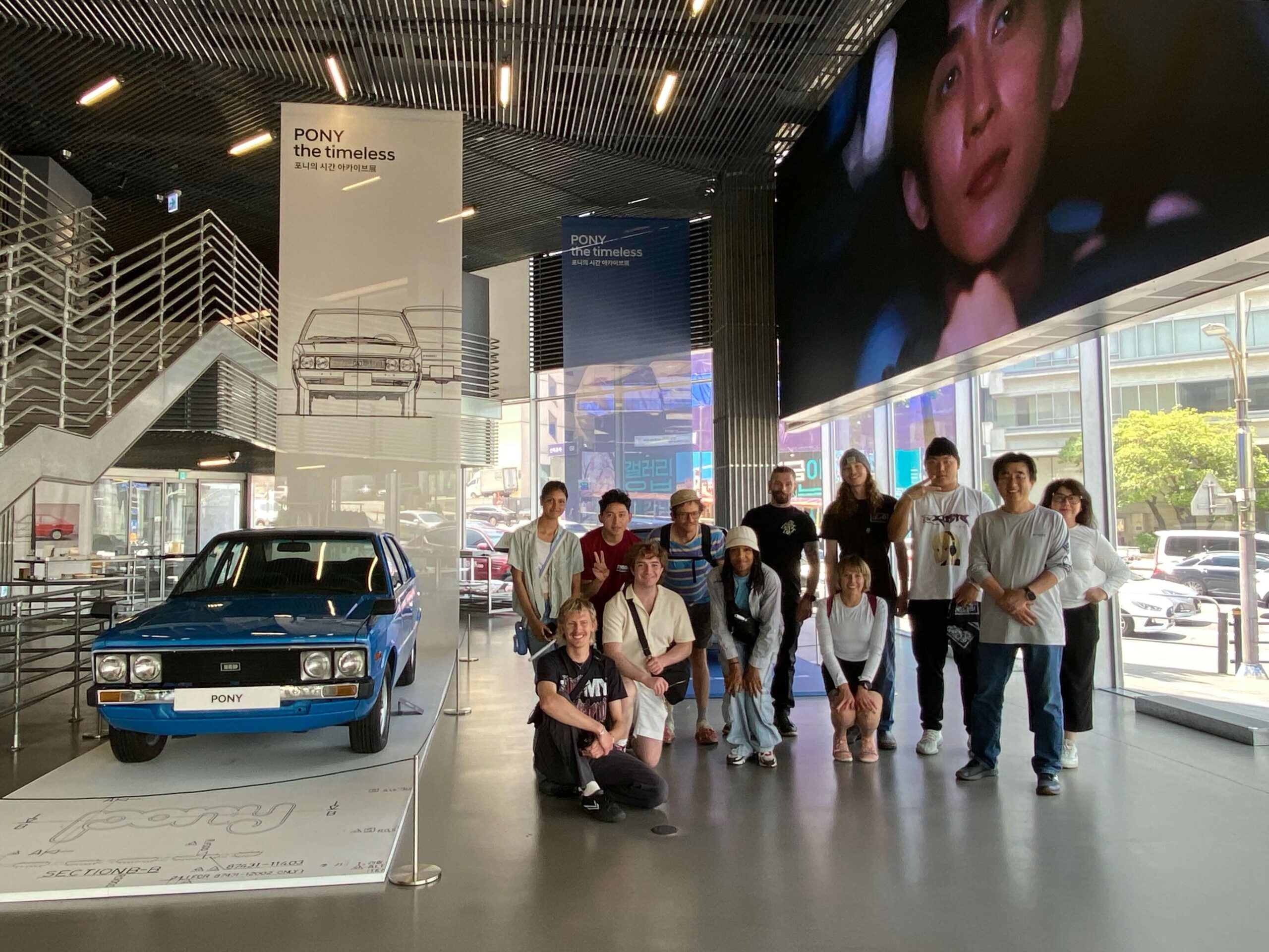 Students standing next to museum cars at the Hyundai Design Center, in Seoul, South Korea