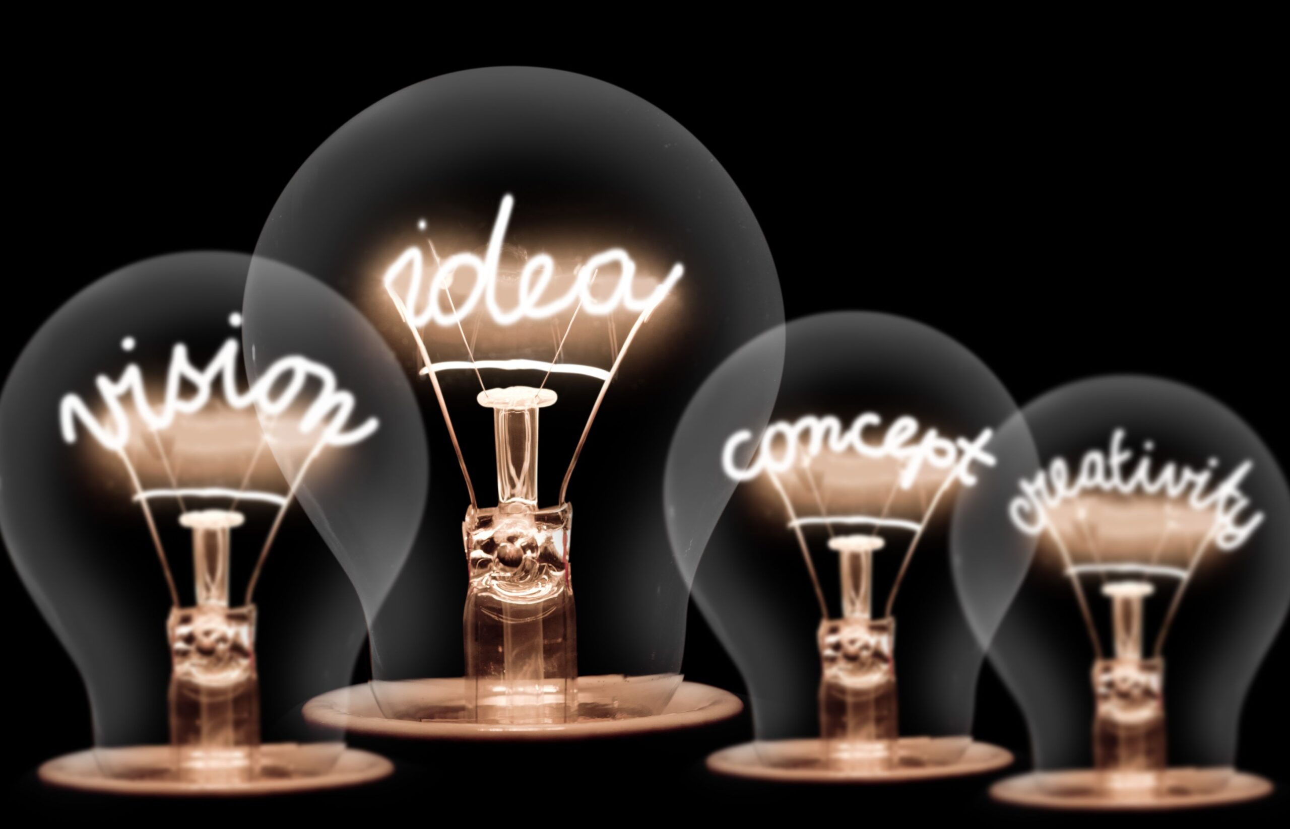 Four light bulbs with the words Vision, Idea, Concept, Creativity