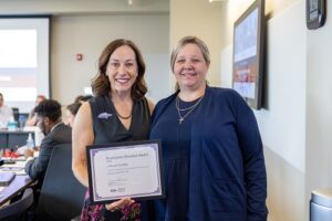 J. Renee Trombley accepting Roadrunner Shoutout Award from Janine Davidson.