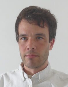 Image of man in white shirt.