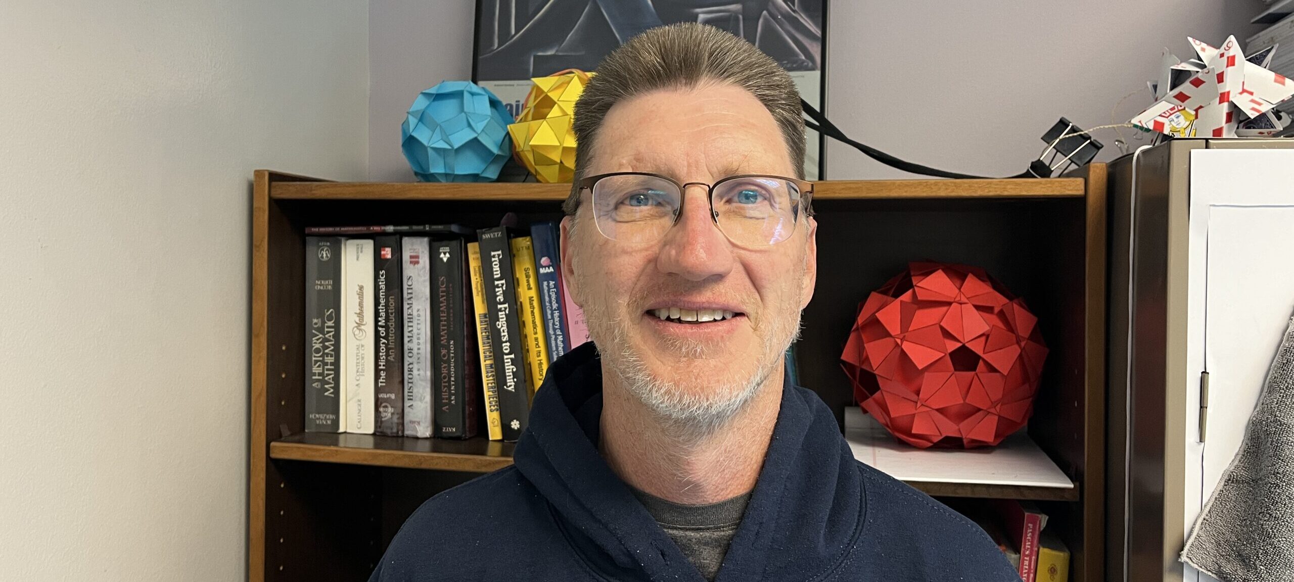 Dr. John Carter smiling in his office