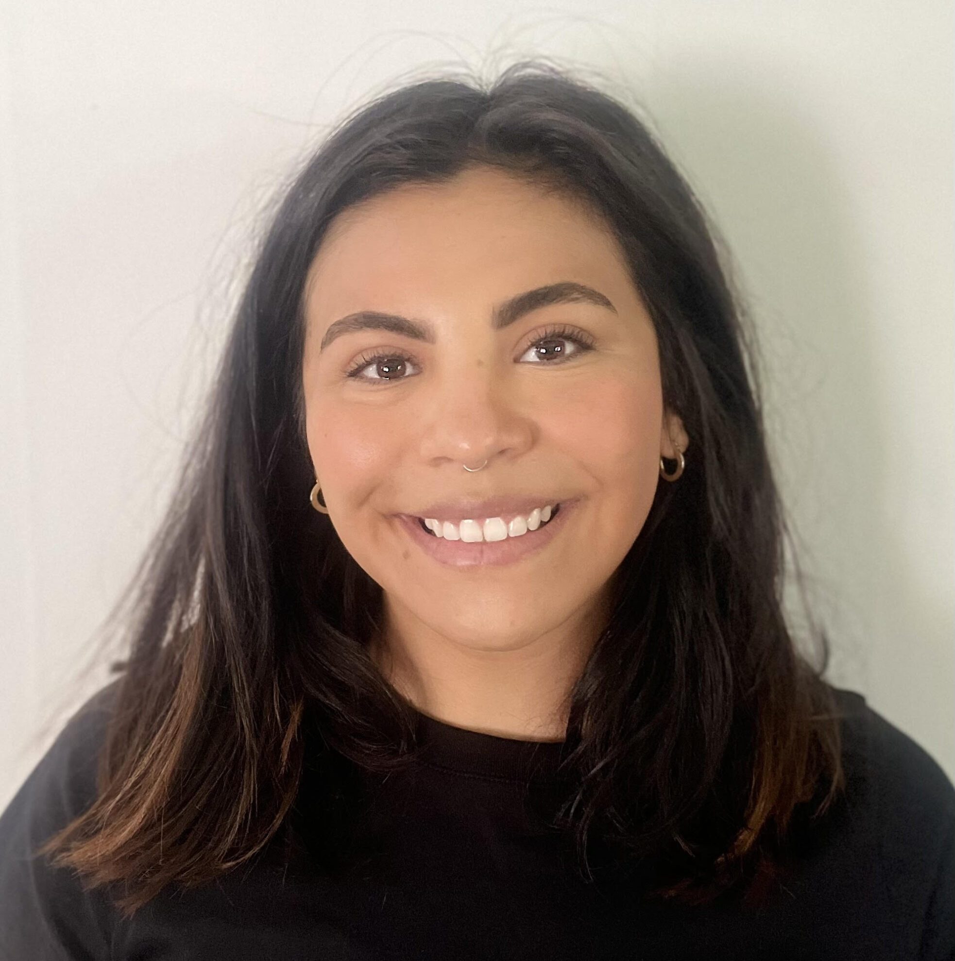 Stephanie Sandoval headshot on white wall