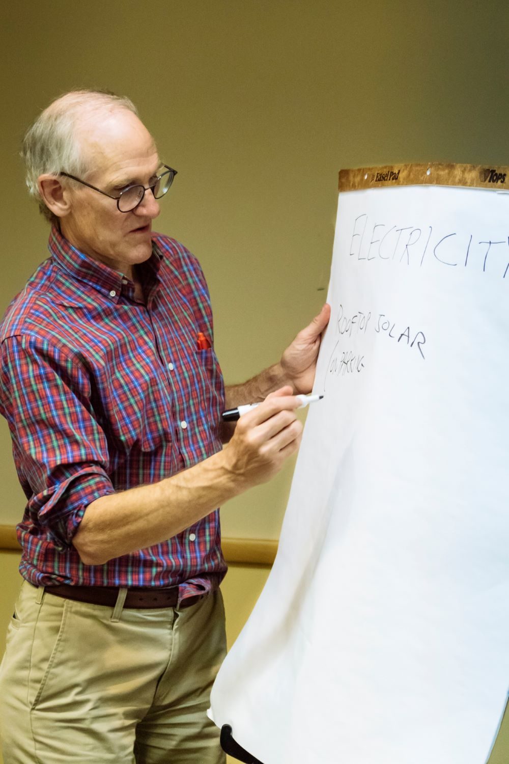 MSU Denver faculty writing notes in black ink on a large pad of paper