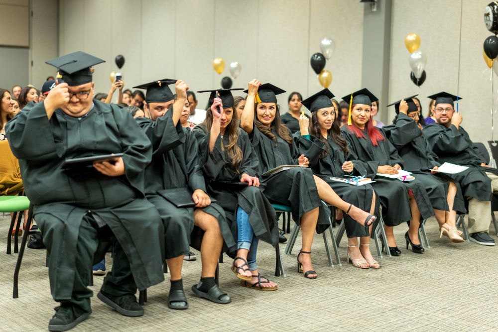 GED Program Graduates in cap and gown