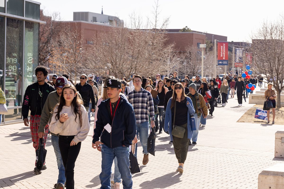 A crowd of people walk into the MSU Denver Open House