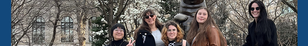 MSU Denver students smiling with a bear stature and trees in the background