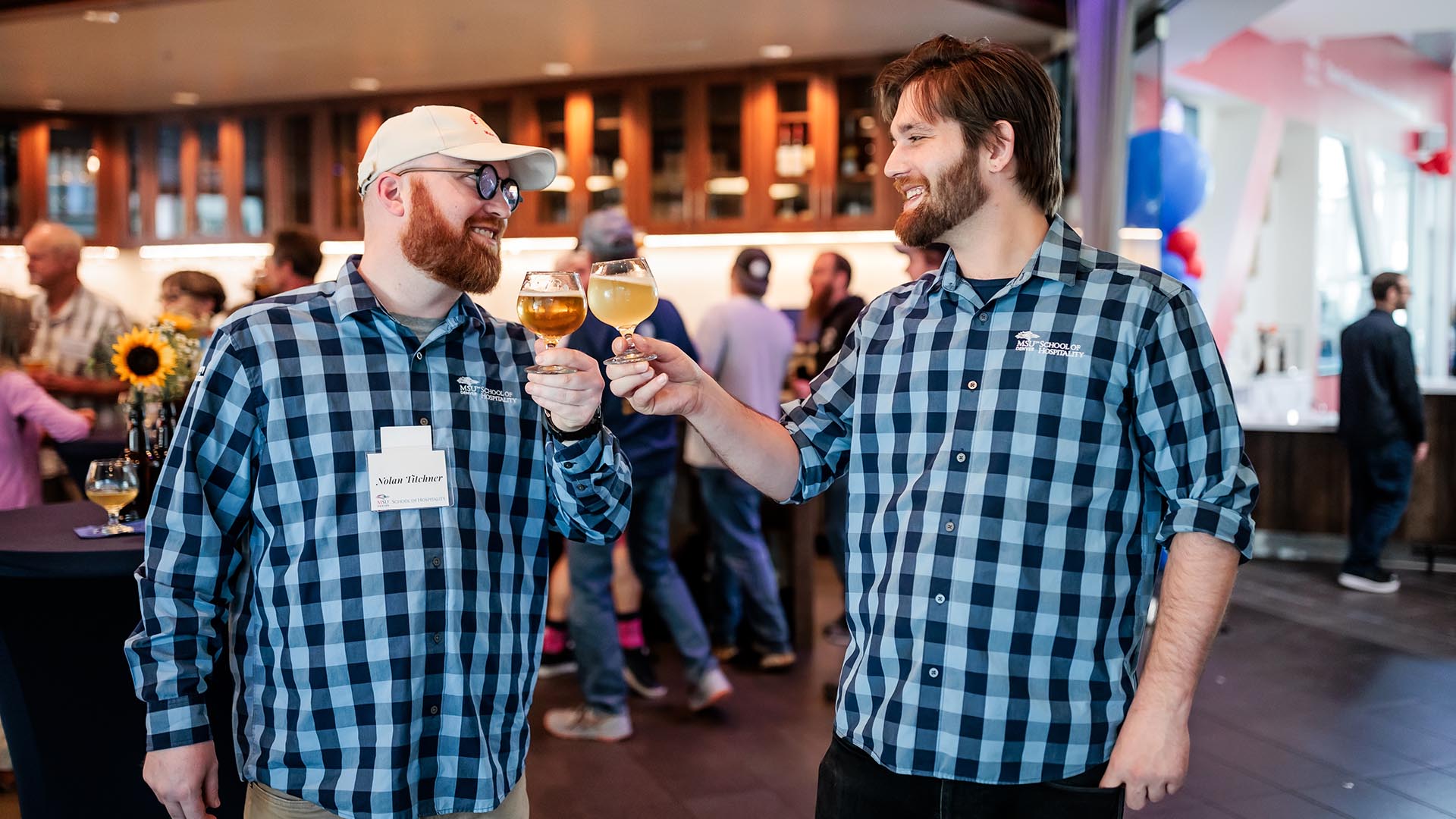 school of hospitality student brewers cheersing