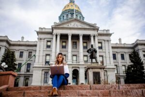 Fatema Tasnim studies with a laptop in front of the Denver Capitol Building