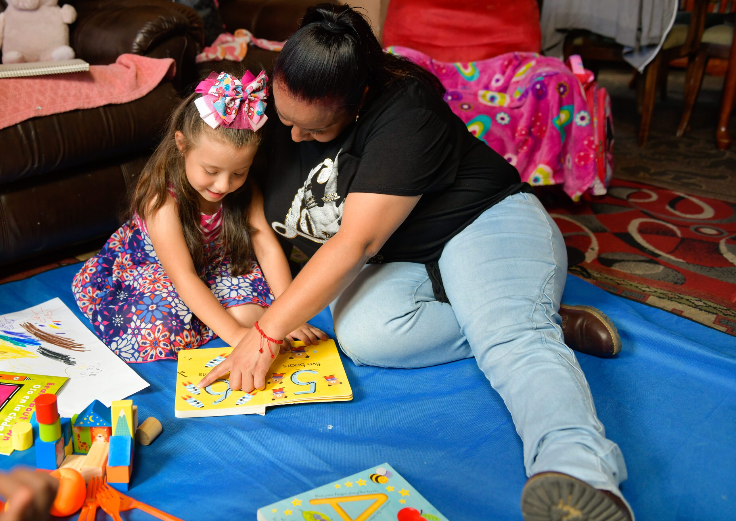 A parent and a child during a home visit read a book together