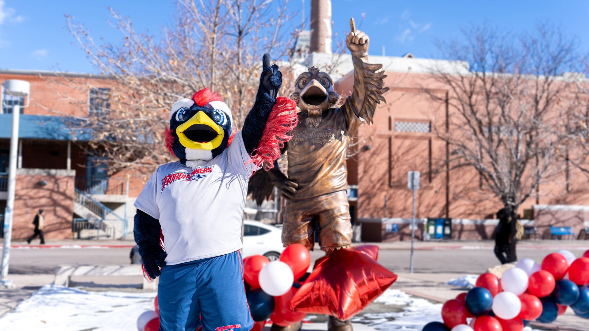 Rowdy the mascot standing in front of the Rowdy Statue during the statue unveiling in front of the Tivoli in January 2024.