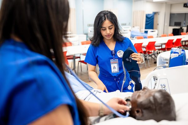 MSU Denver nursing students Marisa Schreiner, L, listens to lung sounds with a fellow student, Jimena Malta on Aug. 12, 2024, at the Simulation and Skills Laboratory.