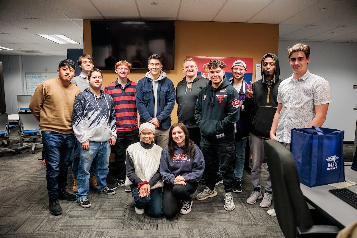 MSU Denver Alum and ESPN anchor, Gary Striewski, C, Poses for a photo with journalism students