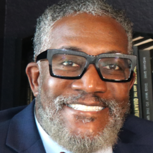 Professional portrait of Dr. Alfred Tatum.