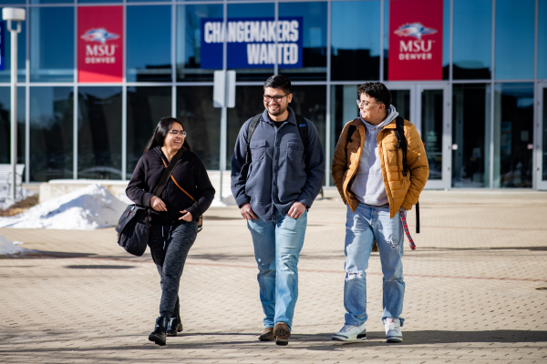 three students walking together and smiling on the MSU Denver campus