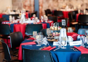 A table at the 2024 Scholarship Celebration set up for guests with drink glasses, food, plates, and silverware