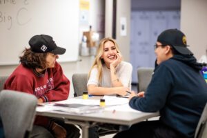 students conversing at desk