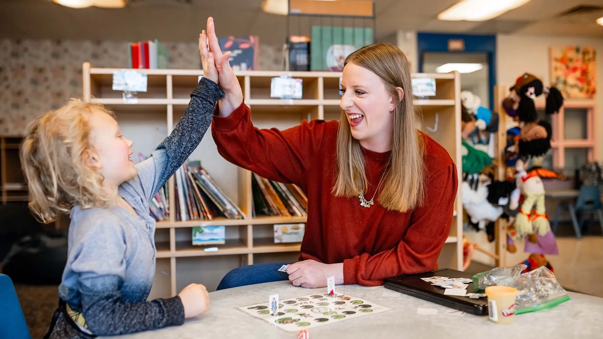 Speech, Language, Hearing Sciences student Abby Marroon plays an articulation game with Monty Manley, 4, at the Auraria Early Learning Center.