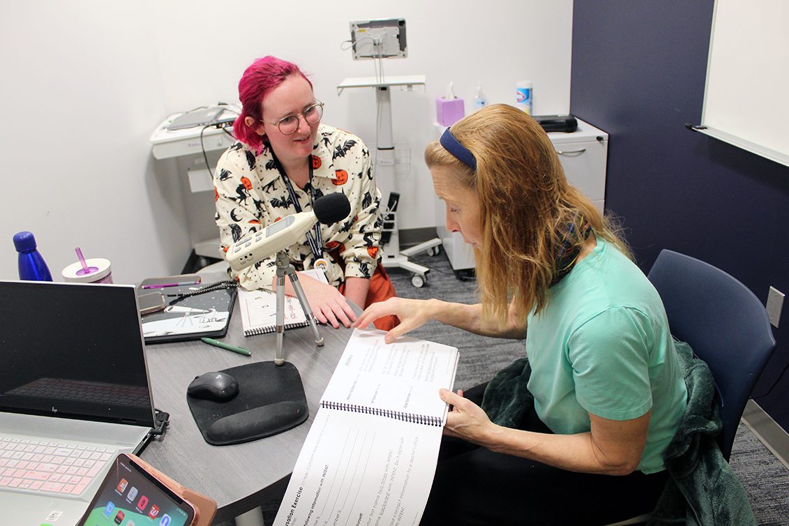 Graduate clinician (middle) and client (right) working on Parkinson Voice Therapy