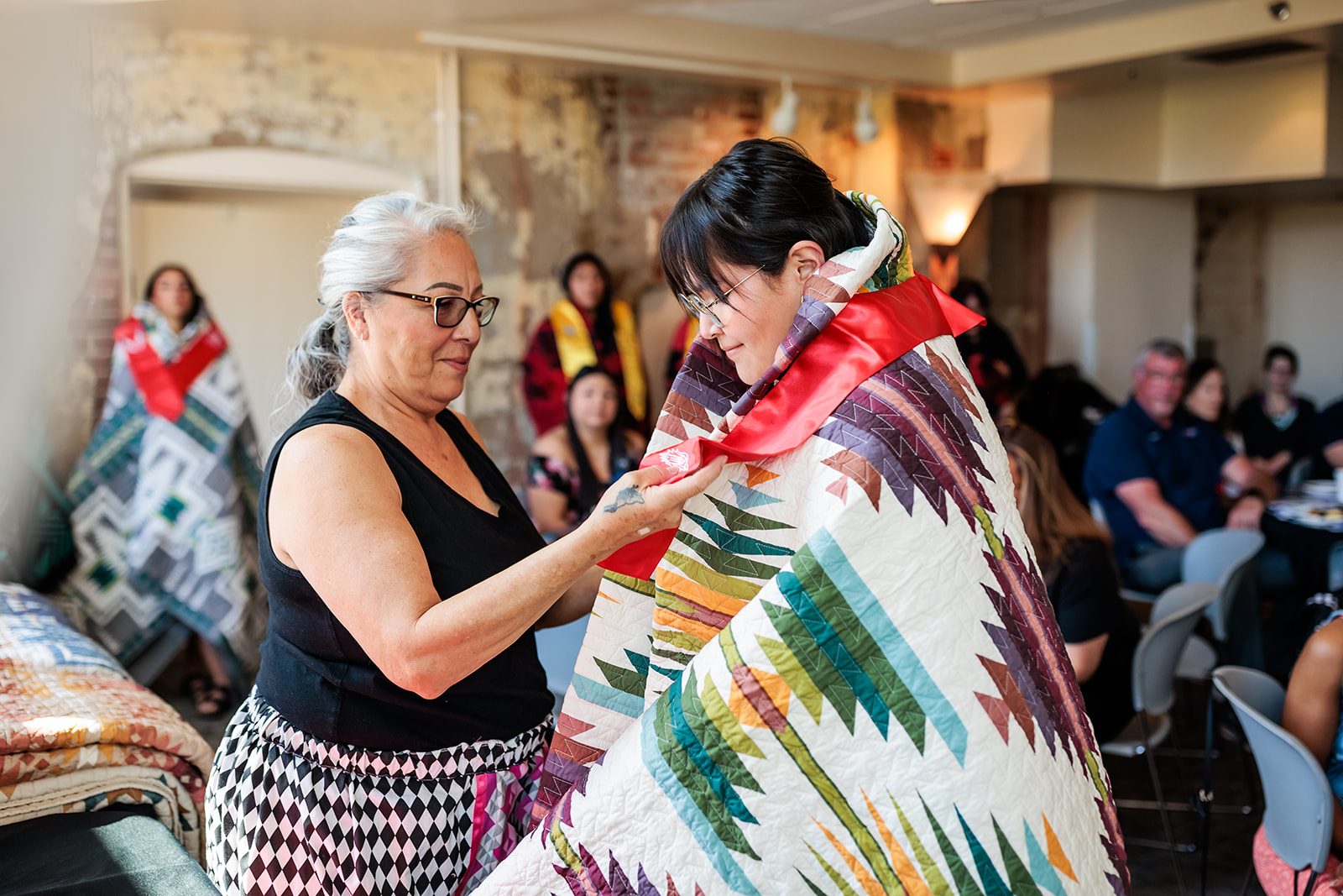 Student receiving blanket at Native Indigenous Graduation Celebration