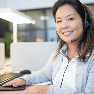 Person with a headset working at a computer