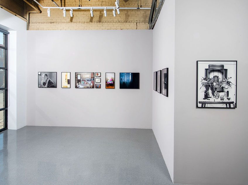 Art gallery at CVA with various sized and multicolored photographs on the walls.